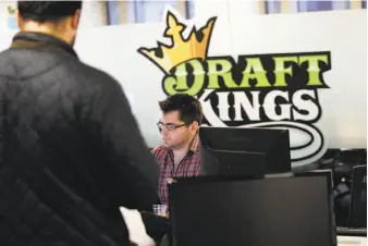  ?? Charles Krupa / Associated Press ?? An employee works at the DraftKings office in Boston. The leading daily fantasy sports company probably will have plenty of competitio­n for sports bettors’ money.