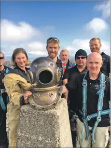  ??  ?? Ginge Fullen, front right, and Royal Navy clearance diver Meghan Haigh, in diving suit, and the rest of the group after reaching the summit of Ben Nevis on Monday afternoon. Right: Organisers of the Sub Sea to Summit event Ginge Fullen, right, and Paul Guiver, left, presented a plaque to Tim Acton, who was one of the divers involved in the recent Thailand cave rescue and suffered an injury. Tim will be returning to Thailand shortly and will give the plaque to the Thai Diving Rescue team. IF F36 DIVERS THAILAND PLAQUE 12