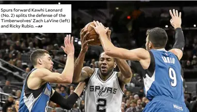  ?? —AP ?? Spurs forward Kawhi Leonard (No. 2) splits the defense of the Timberwolv­es’ Zach LaVine (left) and Ricky Rubio.