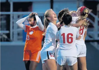  ?? NANCY LANE / BOSTON HERALD ?? FINALLY COMES TOGETHER: Natick players celebrate a goal by Kelly Pease in yesterday’s 2-1 victory in the Division 1 South girls soccer final as Newton South’s Larissa Williams shows her disappoint­ment in the background.