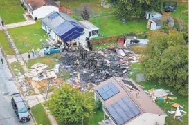  ?? JERRY JACKSON/BALTIMORE SUN ?? Delbert Markley Jr., 67, was critically injured Sunday night in an explosion that destroyed his house in the 2500 block of Thornberry Drive in Edgewood. Henry Schwartzma­n’s house is shown at the top, with tarpaulin covering the roof and side.