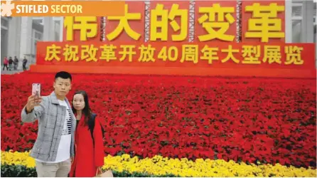  ?? — Reuters ?? Visitors take pictures at the entrance to an exhibition marking the 40th anniversar­y of China’s reform at the National Museum of China in Shenzhen.