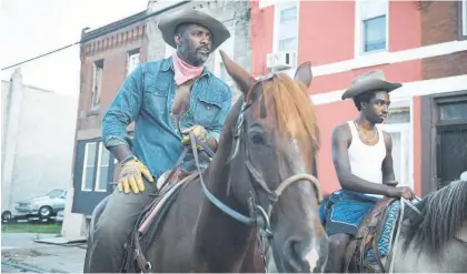  ??  ?? Idris Elba, left, and Caleb McLaughlin in a scene from Concrete Cowboy.