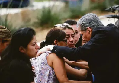  ?? Dario Lopez-Mills / Associated Press ?? The Archbishop of San Antonio, Gustavo Garcia Seller, comforts families outside of the Civic Center following a deadly school shooting at Robb Elementary School in Uvalde, Texas on Tuesday.