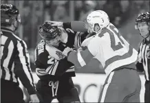  ?? MICHAEL DWYER/AP PHOTO ?? Boston’s Joakim Nordstrom, left, fights Detroit’s Luke Witkowski during the second period at the TD Garden. The Bruins lost, 4-2.