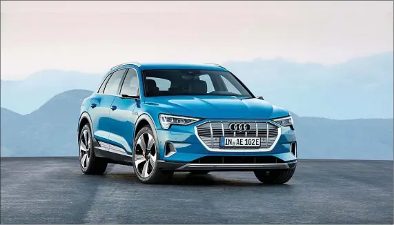  ??  ?? The wrap-around shoulder line extends from the headlights, along the flanks, to the rear lights, giving the Audi E-Tron a low visual centre of gravity.