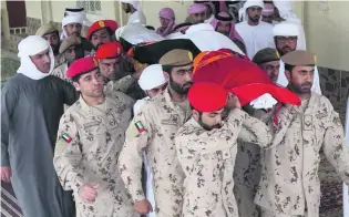  ?? Satish Kumar / The National ?? The body of Juma Al Kaabi, Ambassador to Afghanista­n, is carried to its rest after funeral prayers in Ras Al Khaimah. His usually quiet home town thronged with mourners.