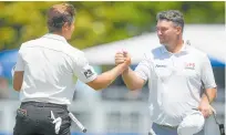  ?? Photo / AP ?? Garrick Higgo (left) greets Ryan Fox on the ninth green.