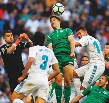  ?? AP ?? Leganes’ Unai Bustinza (top) outjumps Real Madrid players during a La Liga match at the Santiago Bernabeu stadium in Madrid on Saturday.