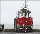  ??  ?? Boatowners in the coastal village of Carrigahol­t on the west coast of Ireland were braced for the storm