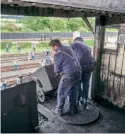  ?? ?? Loading coal from the tower into a locomotive below on August 31, 2020. The original half-ton capacity coal loading tubs and dumping mechanism are still in use. FRANK DUMBLETON