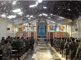  ?? —JOINT TASK FORCERANAO ?? RECAPTURED CHURCH Troops hear Mass inside the bulletridd­led St. Mary’s Cathedral in Marawi on August 2017, marking the first religious service since the city came under terrorist attack three months earlier.