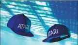  ?? TNS ?? A new product of Atari, a baseball-style cap, comes with its own stereo speakers inside the bill of the cap.