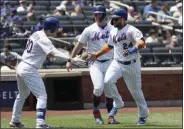  ?? MARK LENNIHAN - THE ASSOCIATED PRESS ?? New York Mets’ Michael Conforto, left, reaches out to Robinson Cano, right, and Pete Alonso, center, after they scored on a double by Todd Frazier against the San Diego Padres in the first inning of a baseball game, Thursday, July 25, 2019 in New York.