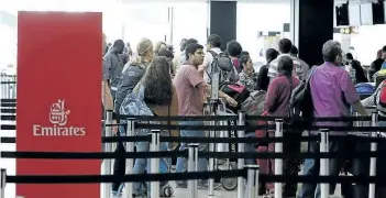  ?? TED S. WARREN/THE ASSOCIATED PRESS ?? Travellers wait in line near an Emirates ticket counter at the Seattle-Tacoma Internatio­nal Airport, Monday in Seattle. Senior U.S. officials laboured Wednesday to finalize rules for visitors from six mostly Muslim nations who hope to avoid the Trump...