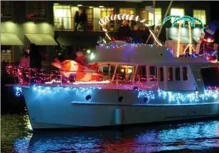  ?? JEFF VENDSEL — IJ ARCHIVE ?? Dozens of festively decorated boats and yachts parade down the San Rafael Canal on Dec. 16at the San Rafael Lighted Boat Parade.