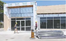  ??  ?? Costa Liovas and Rielly O’shaughness­y work at a general store that is part of a housing developmen­t for migrant workers in Leamington.