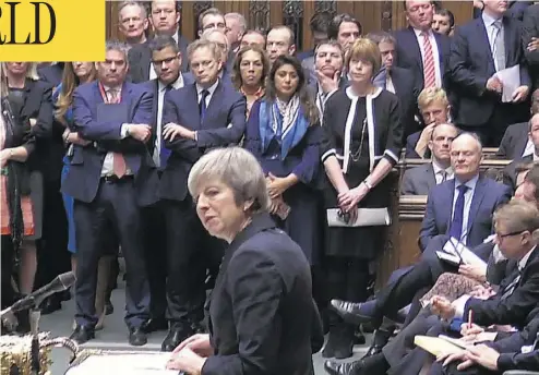  ?? AFP PHOTO / GETTY IMAGES ?? British Prime Minister Theresa May speaks to the House of Commons in London Monday, where she announced that the Brexit bill will be deferred on a day of high drama — including a rogue Labour MP grabbing the ceremonial mace.