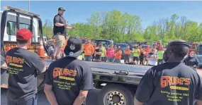  ?? RICARDO TORRES / MILWAUKEE JOURNAL SENTINEL ?? Tim Grube, owner of Grube’s Towing, stands on the back of a truck Saturday and speaks to people mourning Ramon Echeverria. Echeverria died May 29 after being hit by a truck on I-94.