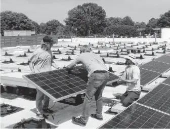  ?? John Grace ?? A solar panel is installed on the Immaculate Conception Catholic Church in Hampton, Va. The solar array now fully powers the church and was installed with Catholic Energies, a nonprofit program of the Catholic Climate Covenant that helps churches build solar power projects.