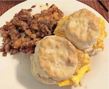  ?? [PHOTO BY DEBRA BRUNO, FOR THE WASHINGTON POST] ?? Eggs in a fluffy biscuit and spicy home fries are a favorite at The Pigeon Hole in Charlottes­ville, Virginia.