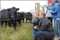  ?? NEWS FILE PHOTO CHARLES LEFEBVRE ?? Nicole Giesbrecht and son Liam look at the cattle at Arrowhead Ranch near Dunmore during Alberta Open Farm Days last summer. Arrowhead Ranch, as well as Neubauer Farms, will be taking part in this year’s Open Farm Days, which runs Sunday.