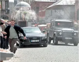  ??  ?? James Bond stuntman Ben Collins (left) and on set in a car chase scene for the new film, Skyfall.