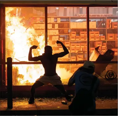  ?? Picture: Carlos Gonzalez/star Tribune via AP ?? A blaze at an Autozone store as protesters hold a rally for black American George Floyd in Minneapoli­s, after his death in police custody sparked a stand-off with officers