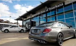  ?? Staff photo by Hunt Mercier ?? ■ A MercedesBe­nz sits at the main entrance of Mercedes-Benz of Texarkana on Thursday during its grand opening. The newly expanded building was remodeled to Mercedes’ standards with the parts department being in-house. The local business has increased inventory by 60 percent.