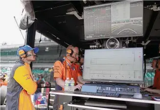  ?? Darron Cummings/Associated Press ?? NASCAR driver Kyle Larson watches practice for the Indianapol­is 500 from an Arrow McLaren pit box at the Indianapol­is Motor Speedway on Thursday.