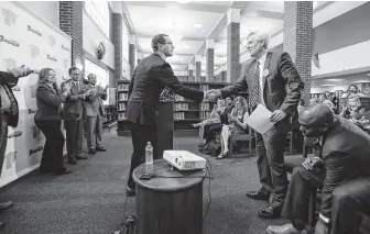  ?? Photos by Steve Gonzales / Staff photograph­er ?? TEA Commission­er Mike Morath, left, congratula­tes Pearland ISD Superinten­dent John Kelly for his schools’ scores in the 2017-18 accountabi­lity ratings.