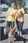  ??  ?? Anna Naquin (left) walks shelter dog Ellie May while her mother, Lisa Naquin, carries foster failure Jetta. The Naquin family fostered Jetta while she was nursing her two puppies and decided to add Jetta to their family through adoption. The Naquins...