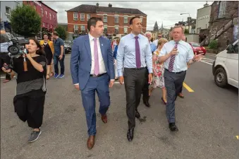  ??  ?? FG Cllr. John Paul O’Shea, An Taoiseach, Leo Varadkar and Minister Michael Creed take to the town in Macroom on Friday last. Photos: John Delea