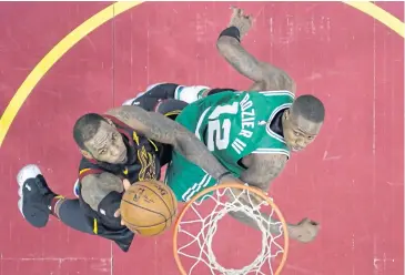  ?? AP ?? The Cavaliers’ LeBron James, left, drives to the basket against the Celtics’ Terry Rozier.