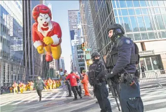  ?? Mary Altaffer / Associated Press ?? New York officers patrol the Macy’s Thanksgivi­ng Day Parade. Officials took no chances after the truck attack near the World Trade Center and the Las Vegas shooting, both in October.