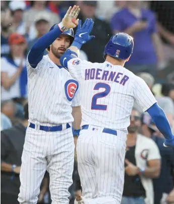  ?? PAUL BEATY/AP ?? Cubs shortstop Dansby Swanson greets second baseman Nico Hoerner, who hit a home run in the first inning off Rays left-hander Shane McClanahan. It was Hoerner’s fourth homer of the season.