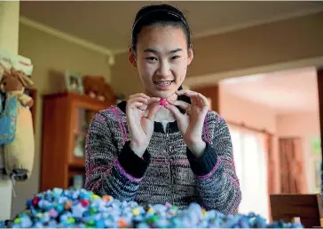  ?? PHOTO: DAVID UNWIN/ FAIRFAX NZ ?? Claire Shi organised Palmerston North Girls’ High pupils to create 20,000 origami stars to celebrate the hypothetic­al 20,000 year orbit of Planet Nine.