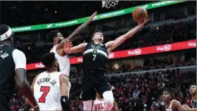  ?? (AP/Nam Y. Huh) ?? Milwaukee Bucks guard Grayson Allen (7) drives to the basket past Chicago Bulls guard Coby White during the second half of Game 3 of their NBA Eastern Conference playoff series Friday in Chicago. Allen had 22 points in a 111-81 victory for the Bucks, who went up 2-1 in the series.