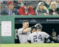  ?? N.Y. Post: Charles Wenzelberg (2) ?? BOOM! BOOM! Gary Sanchez, watching his massive three-run homer (right) — his second dinger of the game — in the seventh inning in Saturday’s 6-2 victory over the Red Sox in ALDS Game 2, celebrated his first homer back in the Yankees dugout with Aaron Judge.