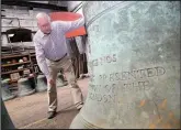  ??  ?? ■ Andrew Wilby looks at St Paul’s Cathedral’s tenor bell, which is being refurbishe­d in Loughborou­gh. Picture by Studio 17