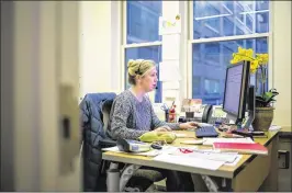  ?? AL DRAGO / THE NEW YORK TIMES ?? Kate Voigt, associate director of liaison at the American Immigratio­n Lawyers Associatio­n, participat­es Tuesday in a conference call in her office in the Penn Quarter neighborho­od of Washington, D.C.