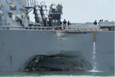  ?? U.S. NAVY/GETTY IMAGES ?? USS John S. McCain steers toward Changi Naval Base in Singapore, after it collided with an oil tanker in Southeast Asian waters.