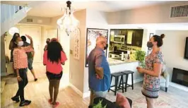  ?? CARLINE JEAN/SOUTH FLORIDA SUN SENTINEL ?? Potential homebuyers view a three-bedroom, two-and-a-half-bath townhome during an open house in Plantation last year.