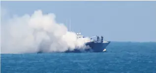  ?? SAID KHATIB/AFP/Getty Images ?? Smoke billows from an Egyptian naval vessel on the maritime border between Egypt and the Palestinia­n Gaza Strip, off the coast of Rafah, on Thursday. The Egyptian army said the
vessel was set ablaze during a clash with militants in the restive Sinai...