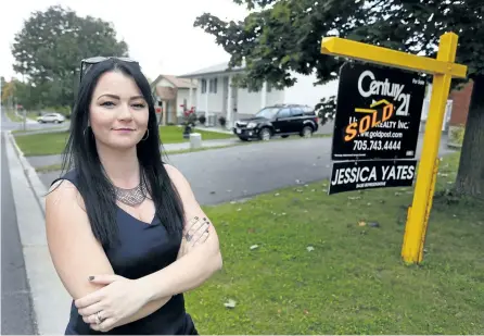  ?? CLIFFORD/SKARSTEDT/EXAMINER ?? Jessica Yates, a realtor with Century 21 United Realty, stands next to a home that she recently sold in the city's north end on Thursday. Yates recently made the Real Estate Profession­al magazine's 2017 Young Guns list for excelling in her field.