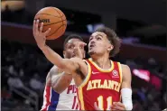  ?? THE ASSOCIATED PRESS ?? Hawks guard Trae Young (11) makes a layup as Pistons guard Rodney McGruder defends.