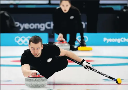  ?? THE ASSOCIATED PRESS ?? In all likelihood, Russian curler Alexander Krushelnit­sky and his wife Anastasia Bryzgalova (background) will have their bronze medals in mixed doubles curling taken away after Krushelnit­sky tested positive for the banned substance meldonium.