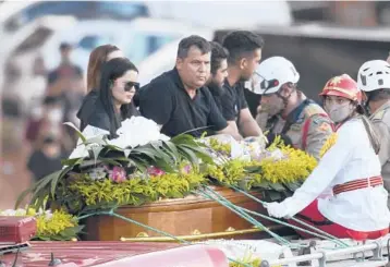  ?? MATEUS BONOMI/GETTY ?? Tens of thousands of fans gather Saturday in Goiania, Brazil, to pay tribute to Marilia Mendonca, one of Brazil’s most popular singers, who was killed a day earlier in an airplane crash at age 26. The singer and four others perished Friday when their plane crashed while flying from Mendonca’s hometown of Goiania in Goias state.