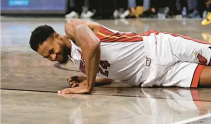  ?? ADAM HUNGER/AP ?? Heat forward Haywood Highsmith reacts after falling against the Nets during the second half Nov. 25 in New York.