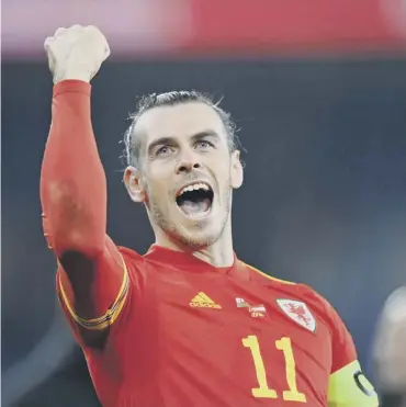  ?? ?? Wales captain and two-goal hero Gareth Bale celebrates following his side’s victory over Austria